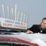 Rabbi Bruk with a car menorah 
